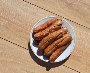 
fresh fried nipples lie on a plate on a wooden table
