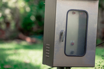 The blurred abstract background of an electric control cabinet that exists between public gardens or the streets, for the convenience of emergency remedies in the event of a power failure.