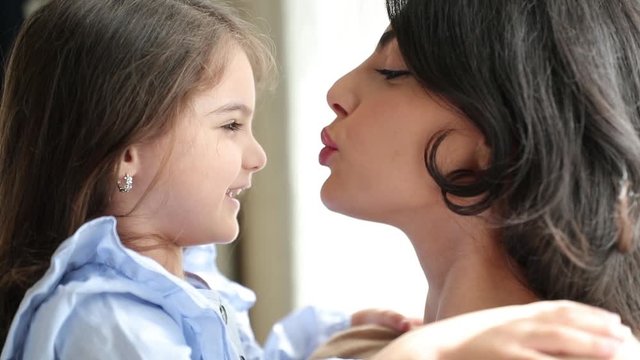 Slow motion 4K, three year old girl Beautiful Mother And her baby girl. Beauty Mom and her baby girl play together Kissing and hugging happy family. Mother's Day Joy.