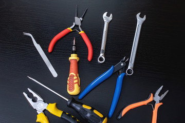 Screwdrivers and pliers, tools on wooden table