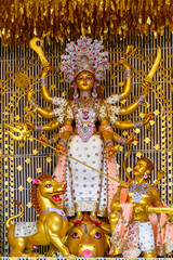 Idol of Goddess Devi Durga at a decorated puja pandal in Kolkata, West Bengal, India. Durga Puja is...
