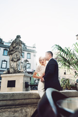 Fototapeta premium Bride and groom. Close-up portrait of a man in a suit and a woman with blond hair in a white dress on the wedding day.