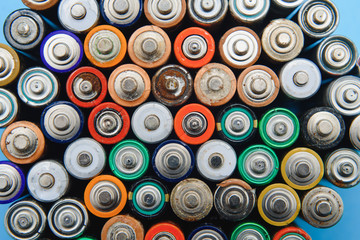 Close up of positive ends of colorful discharged batteries of different sizes and formats, top...