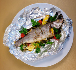 Greek trout baked in foil with lemon and herbs in Greek