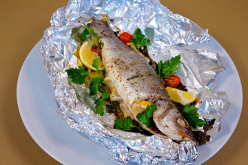 Greek trout baked in foil with lemon and herbs in Greek