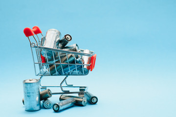 many used AA batteries on a blue background.