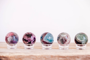 Crystals in the form of balls on a wooden table. Copy, empty space for text