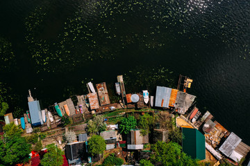Obraz premium multi-colored boats on the pier near the river are shot from a height in the summer