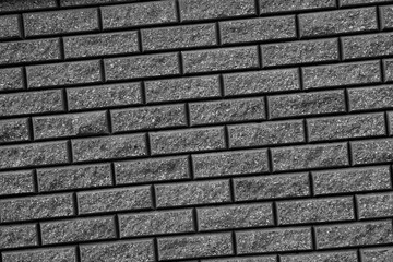 Gray background with black geometric patterns. Gray wall of rectangular stones, bricks or tile. 