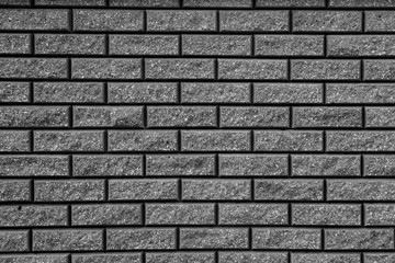 Gray background with black geometric patterns. Black wall of rectangular stones, bricks