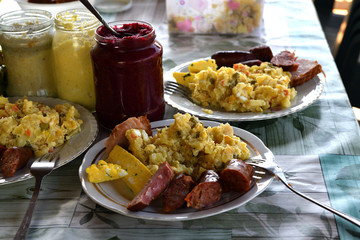 Easter table with salad, eggs, ham, sausage, beetroot and horseradish