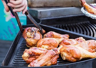 Turkey shanks are cooked on a barbecue grill.