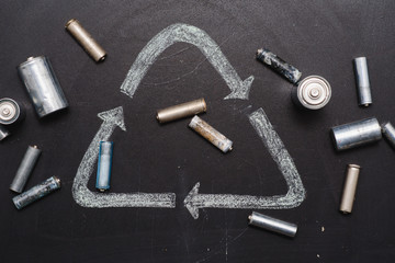 Used batteries on a dark background, the concept of recycling.