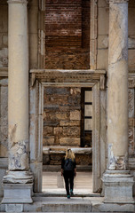 Woman Walking to Ancient  Door