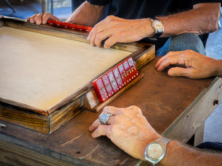 Puerto Rico Unidentified older men's hands playing red dominoes