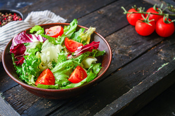 Healthy salad, leaves mix salad (mix micro greens, cucumber, tomato, onion, other ingredients) keto or paleo diet. food background. copy space 