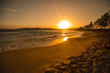 Dramatic sunset sunrise landscape with orange sun over the sea in Punta Cana, Dominican republic 