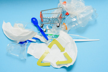 Single use, Disposable tableware and recycling sign on background. Spoons, forks. Plastic...