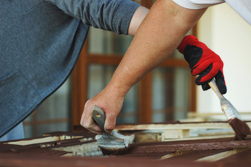 Daughter helping her dad pinting the wood. Zero waste furniture.
