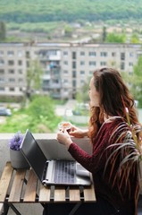 Woman enjoy time on balcony during quarantine. Self education, relax