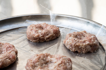 raw pork burger prepareing in metal pan