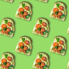 Seamless pattern sandwich cerry tomatoes, with avocado and cottage cheese sauce, sprinkled with celery leaves. Healthy food flatlay in pop art style on a green background.
