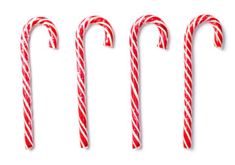 Sweet caramel canes of red color on a white background.