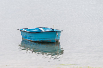wooden fishing boat anchored near the coast.