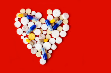Heap of pills, tablets, capsules on red orange background. Drug prescription for treatment medication health care concept wth copy space. Coronavirus 2019,concept of Corona virus quarantine, Covid-19.