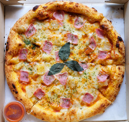 top view of hawii pizza in a paper box