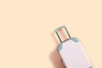 Pink suitcase for travel on a pink background. Summer dreams. Flat lay, copy space, isolated.