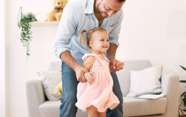Caucasian father playing with his cute loving daughter