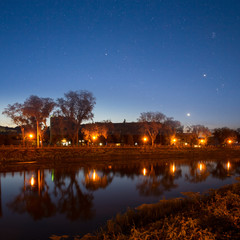 night city embankment with lanterns under a starry sky