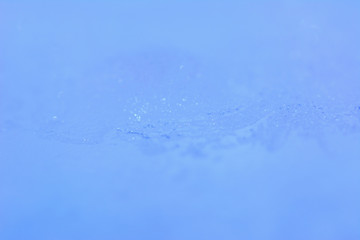 Frozen water blue background.