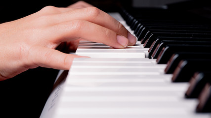 Fototapeta na wymiar child playing to piano close-up photo