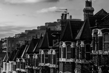 Residential area of London.
Black and white picture of a residential area of London, you can see the clash between the traditional victorian houses and the modern apartment buildings.