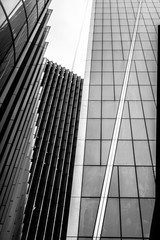 Brutalism and symmetry.
Black and white picture of a group of modern buildings in a business district of a big city.