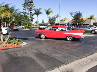 1957 chevy bel air classic car cruises in southern california with florida palm trees