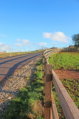 Shadows of a fence on a country road	