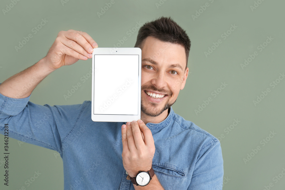 Aufkleber handsome man with tablet computer on color background