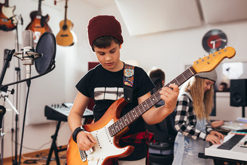 kids rock band playing in music studio