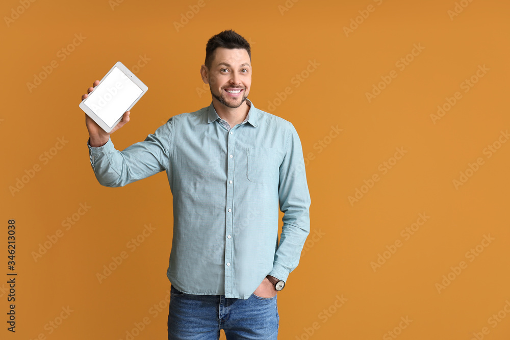 Aufkleber handsome man with tablet computer on color background