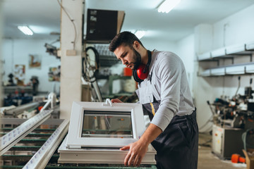 Aluminium and PVC industry worker making PVC or aluminium frames for windows and doors