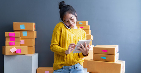 Startup small business SME, Entrepreneur owner using smartphone or tablet taking receive and...