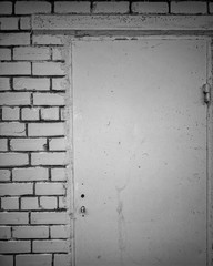 Isolated monochrome closeup dramatic old wall background built white bricks and gray concrete with old doors no handle