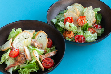 Classic shrimp caesar salad with romaine leaves, croutons, parmesan, tomatoes