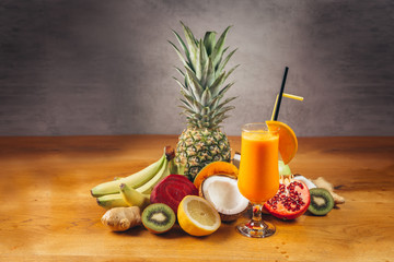 fresh tasty organic fruit juices with fruit arranged on table