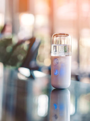 Alcohol nano mist sprayer for hand cleaning to prevent the spread of the corona virus (Covid-19) placed on the table to serve customers before buying in the coffee shop. Modern health technology.