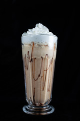 Fresh tasty cocktails. milkshake. Cup of coffee in clear long glass. Isolated. Latte with ice cream and cookies and straw. 