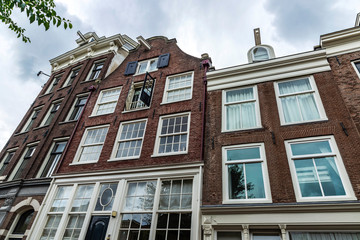 Fototapeta na wymiar Old traditional leaning houses in Amsterdam, Netherlands